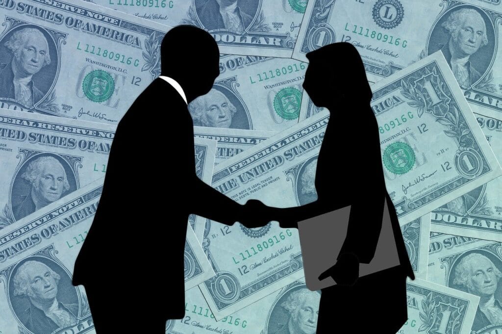 Na imagem ilustrativa, há um homem e uma mulher, ambos empresários, apertando as mãos. A imagem ilustra um pouco do processo de câmbio para pessoa jurídica (PJ), no qual a B2Gether é especializada e oferece soluções inteligentes.